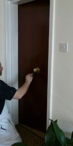 Decorator varnishing a door